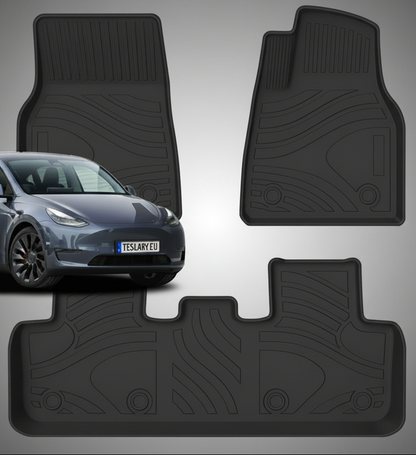Four black rubber car floor mats shown against a pale gray background, with a dark gray car partially visible behind one mat to indicate fitment. No visible brand markings are present.