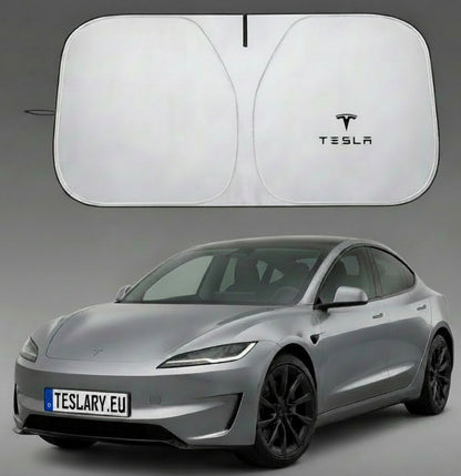 A silver Tesla car shown with a large white car sun shade above it and a folded view of the shade to the left. The sun shade has a black Tesla logo printed on it.