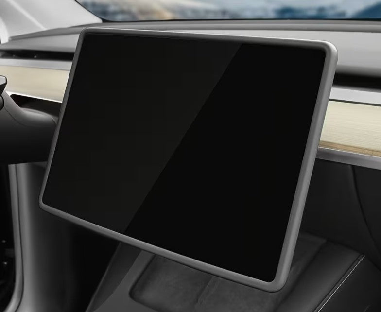 A large black car infotainment touchscreen display with a silver-gray bezel, mounted inside a vehicle dashboard. TESLA_MODEL_Y_JUNIPER_TESLA_MODEL_3_HIGHLAND_16_SCREEN_YL_SCREEN_SILICONE_EDGE_PROTECTOR_BLACK_GREY_WHITE_BUY_FROM_IRELAND_AND_EUROPES_TESLARY.EU_TESLARY.FI_TESLARY.SE_TESLARY.ES_TESLARY.PT_TESLARY.CO.UK_TESLARY.IE