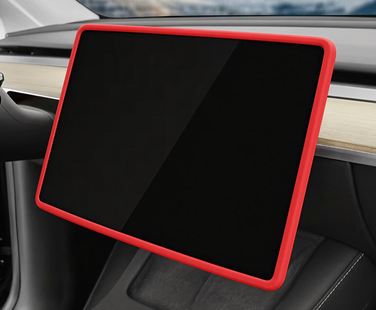 A red protective bumper case fitted around a large black car infotainment touchscreen display, shown installed inside a vehicle dashboard. TESLA_MODEL_Y_JUNIPER_TESLA_MODEL_3_HIGHLAND_16_SCREEN_YL_SCREEN_SILICONE_EDGE_PROTECTOR_BLACK_GREY_WHITE_BUY_FROM_IRELAND_AND_EUROPES_TESLARY.EU_TESLARY.FI_TESLARY.SE_TESLARY.ES_TESLARY.PT_TESLARY.CO.UK_TESLARY.IE