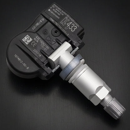 A automotive wheel speed sensor with a black plastic housing and a silver metal shaft, shown on a plain white background.